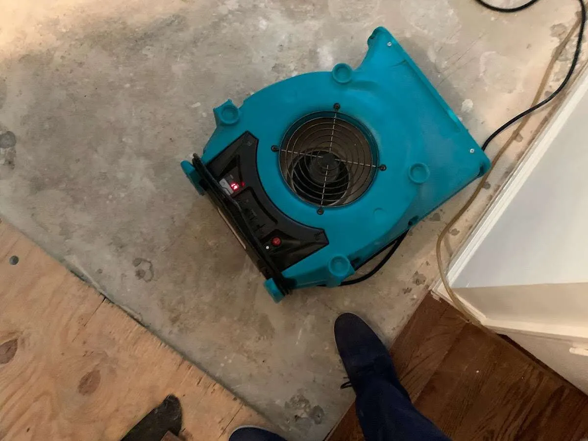 Air mover drying subfloor during Commercial Water Damage Restoration in DuBois